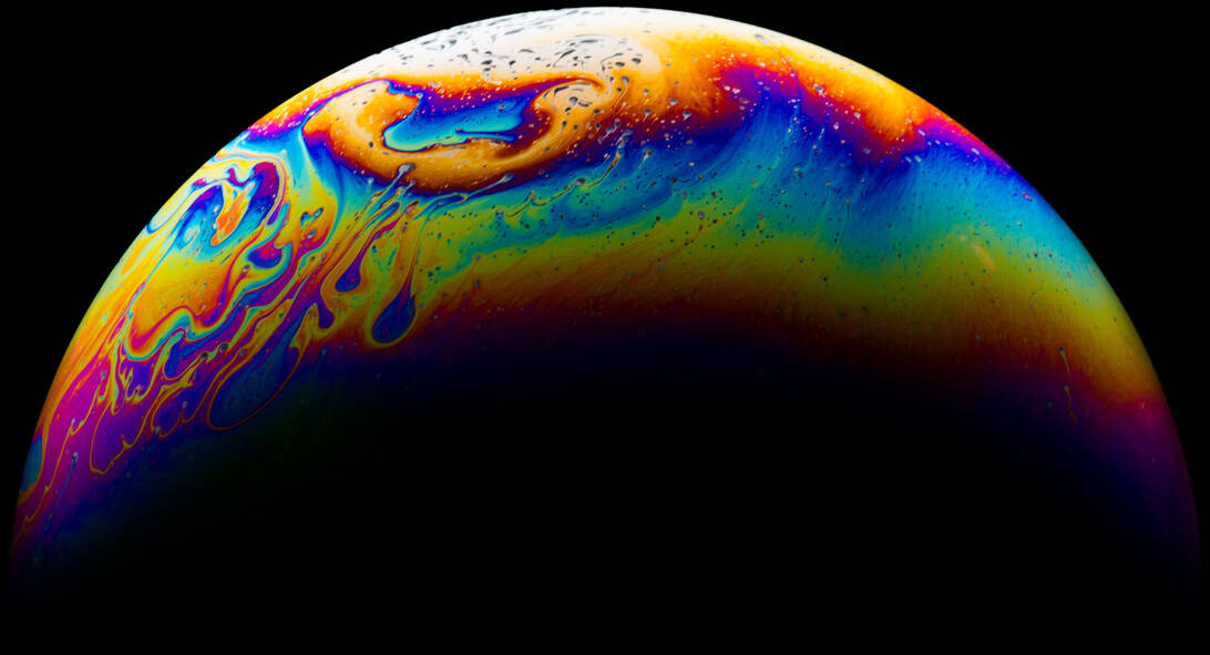 Vivid abstract planetary image with swirling colors and patterns, showcasing artistic interpretation of a cosmic scene or planet with colorful surface textures.